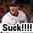 Pixelated image of a person in white sports uniform with red collar, dark cap, and open mouth expression, overlaid with bold black text "Suck!!!!!" on white background.
