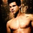 Pixelated image of a shirtless person with dark hair and beard, standing against a dark background.