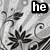 Black-and-white floral patterned background with text overlays reading 'he', 'loves', and 'me<3' in bold white letters on black rectangles.