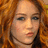 A static image of a person with long, wavy red hair and light skin in four identical arranged in a