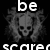 Pixelated black-and-white icon with a skull at center, surrounded by smoke-like effects, and partial text reading 'be' above and 'scare' below.