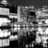 Black-and-white pixelated image with abstract geometric shapes and varying grayscale tones, no discernible figures or text.