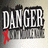 Pixelated static image with large white blocky text "DANGER" on dark background, red X symbol below left of text.