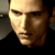 Static pixelated close-up of a person's face with warm lighting and dark clothing, displayed as a 50x50 buddy icon on a gray background.