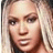 Pixelated close-up of a person with light brown hair, dark eyes, and a neutral expression, cropped to show only the upper face and shoulders.
