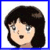 Pixelated cartoon head with dark brown hair, light skin, blue eyes, and open mouth expression on white background.