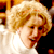 Static 50x50 pixel icon showing a close-up of a person with blonde hair and light skin wearing a white top against dark background elements.