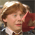 Static pixelated image of a character with light brown curly hair, wearing a white collared shirt and dark jacket with red fabric visible on the right side.