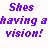 Pixelated purple text reads "Shes having a vision!" on white background next to pixelated person with closed eyes and red clothing.
