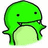 Green pixelated cartoon character with rounded head, small black eyes, and open mouth showing teeth, holding a light green circular object against white background.