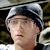 Static 50x50 pixel icon showing a person wearing a light gray cap with dark brim, visible facial features including eyes and mouth, against a blurred background.