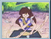 Animated sequence of a girl with long brown hair in a blue and white striped shirt, seated at a table with a dark cloth, manipulating a long light-colored rope against a green and purple background.