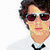 six pixelated images showing a person with curly brown hair in various poses and backgrounds, including one pink with text