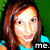 Pixelated portrait of a person with long brown hair wearing a turquoise top against a green background, with 'me.' text in the bottom right corner.