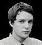 Pixelated grayscale portrait of a person with short hair, closed eyes, and neutral expression against black background.