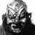 Pixelated grayscale image of a figure with exaggerated facial features, dark clothing, and a wide grin showing teeth.