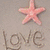 A static image shows a pink starfish above the word 'love' written in sand, with waves and 'I ❤️ U' below.