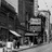Black-and-white pixelated image of a theater interior with seats, a stage, and architectural details.