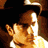 Pixelated static image of a person in motion with warm brown and orange tones against dark background, likely from a historical digital animation or film reference.