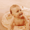 A baby in a white tub with a pink background transitions to a person wearing a colorful flower headpiece against a blue background.