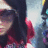 Pixelated static image shows partial figure with dark hair, red garment, and light background with blue and purple tones.