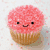 Pixelated cupcake with pink frosting and smiling face, displayed in two views with text overlay reading "Wow that looks TASTY!" on blue-and-white background.