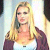 Static 50x50 pixel icon showing a woman with long blonde hair wearing a white top and dark purple cardigan against a light background.