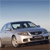 Static pixelated image of a light-colored vehicle on a dirt surface under a gradient sky.