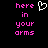 Pixelated text in pink reads 'here in your arms' with a white heart symbol above the text on a black background.