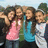 Pixelated group photo of four girls in outdoor setting with bright pink text overlays reading 'julie kristin kimmy ally =' and 'bestt friendss<33' on separate