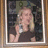 A woman with blonde hair in a dark top holds a glass, drinks from it, and raises her hand to her face across three