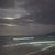 A static pixelated image with horizontal bands of muted gray, brown, and off-white tones, showing no distinct subjects or text.