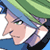 Pixelated anime-style character face with blue hair, green headband, and purple ear accessory against a light background.
