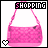 A pink handbag with a patterned surface and a small black heart on its side, displayed under the word 'SHOPPING' with a white heart icon below it.