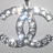 A pixelated silver-toned icon featuring a stylized double-C symbol with reflective highlights on a light gray background.