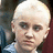 Pixelated image of a person with short light hair and dark eyes, accompanied by green pixelated text reading "OMG ITS MALFOY PUNCH HIM IN THE FACE!!" on white background.