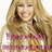 Pixelated image of a person with long light brown hair wearing a pink and white patterned top against a plain background.