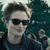 Pixelated image of a person with dark hair wearing black sunglasses and a dark jacket against a teal background.