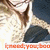A pixelated image shows a person in a white top and dark pants holding an object near their face against a light background with orange text at the bottom.
