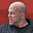 A 48x48 pixel animated contact sheet showing seven sequential frames of a man in dark clothing holding another person with a white headband, set against red and gray background elements.