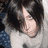 A pixelated image of a person with dark hair lying down on a light surface, next to a large red heart symbol.
