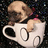 Pixelated image of a small dog in a white cup with heart-shaped cutouts on a dark background, next to pixelated text on a cyan background.