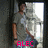 Pixelated image of a person standing in a doorway with bright light behind them, wearing gray shirt and dark shorts.