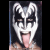Pixelated image of a person with white and black face paint, tongue extended, red text below reading GENE Simmons on black background.