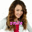 A person with long brown hair wearing a white jacket over a red top, with the word 'smile' in pink pixelated text overlaid on the chest area.