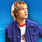 A 48x48 pixel buddy icon featuring a character in a blue jacket over a red-and-white shirt, with text elements including "FRED" and "SCOOBY DOO 2 MARCH 26" on a blue background.