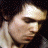 nine pixelated frames showing a person with dark hair and light skin, each frame containing distinct text overlays in a retro digital font