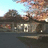 A pixelated image with a dark red background, green text, and a small landscape photo showing a building and sky.
