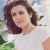 A pixelated image of a person with shoulder-length brown hair wearing a white top, positioned next to green text reading 'Original Icons .com' on a dark background.