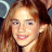 A static pixelated image of a person with long light brown hair, fair skin, and visible teeth in a slight smile.